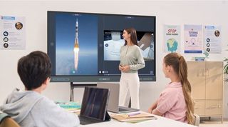 A teacher with a class using a BenQ Board RP04